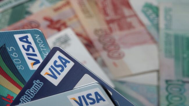 Пластиковые карты и денежные купюры достоинством 1000 и 5000 рублей. Архивное фото